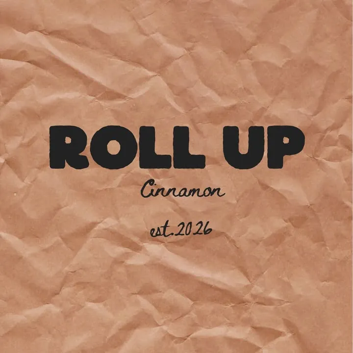 The original Roll Up Cinnamon logo on crumpled kraft paper, est. 2026